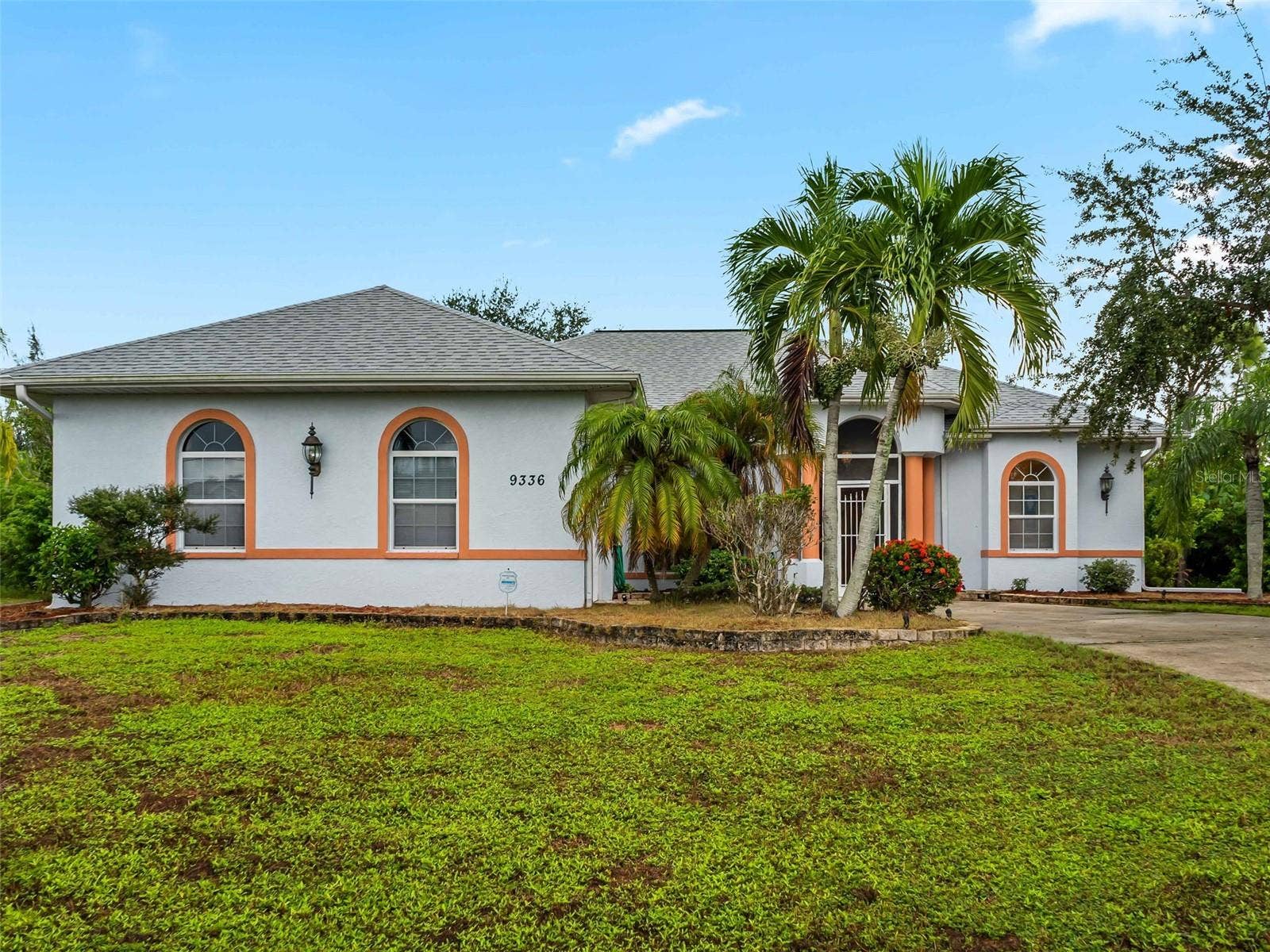 FrontExterior_9336StPaulDr_PortCharlotte_TropicalLandscaping_Daylight.jpg
