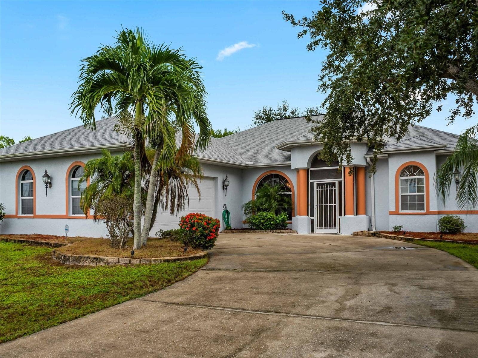 FrontExterior_9336StPaulDr_PortCharlotte_TropicalLandscaping_Corner.jpg