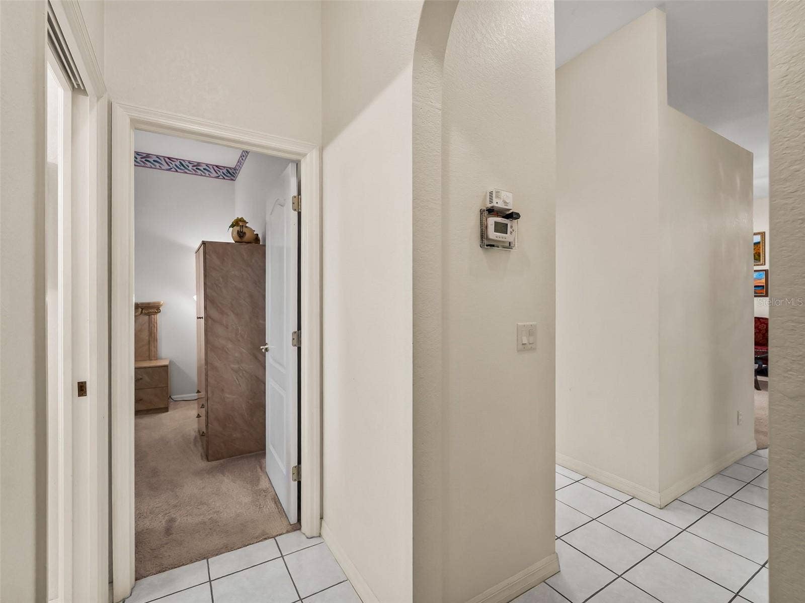 Hallway_9336StPaulDr_PortCharlotte_TileFloors_Corner.jpg