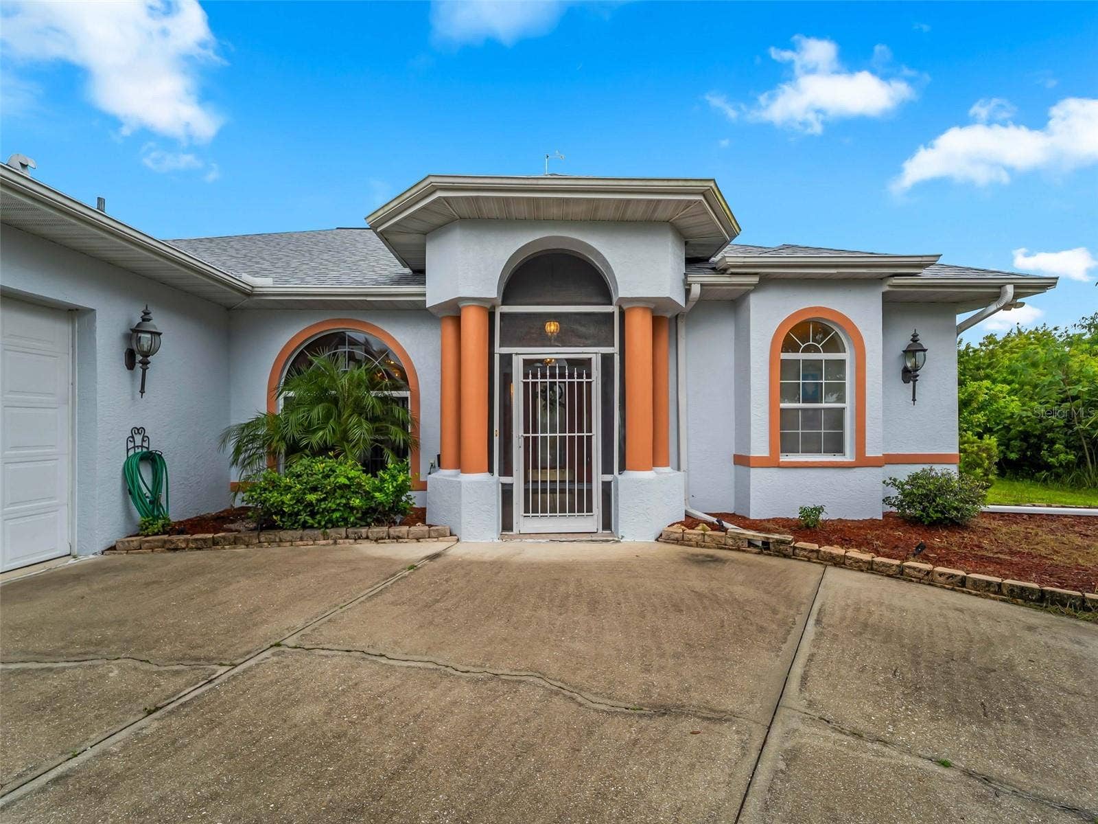 FrontExterior_9336StPaulDr_PortCharlotte_ArchedEntry_Wide.jpg