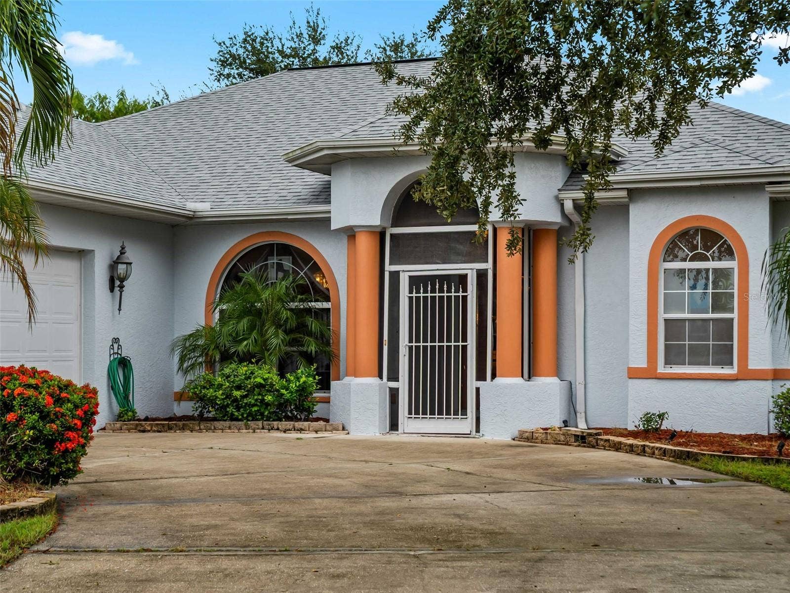 FrontExterior_9336StPaulDr_PortCharlotte_ArchedEntry_Close.jpg