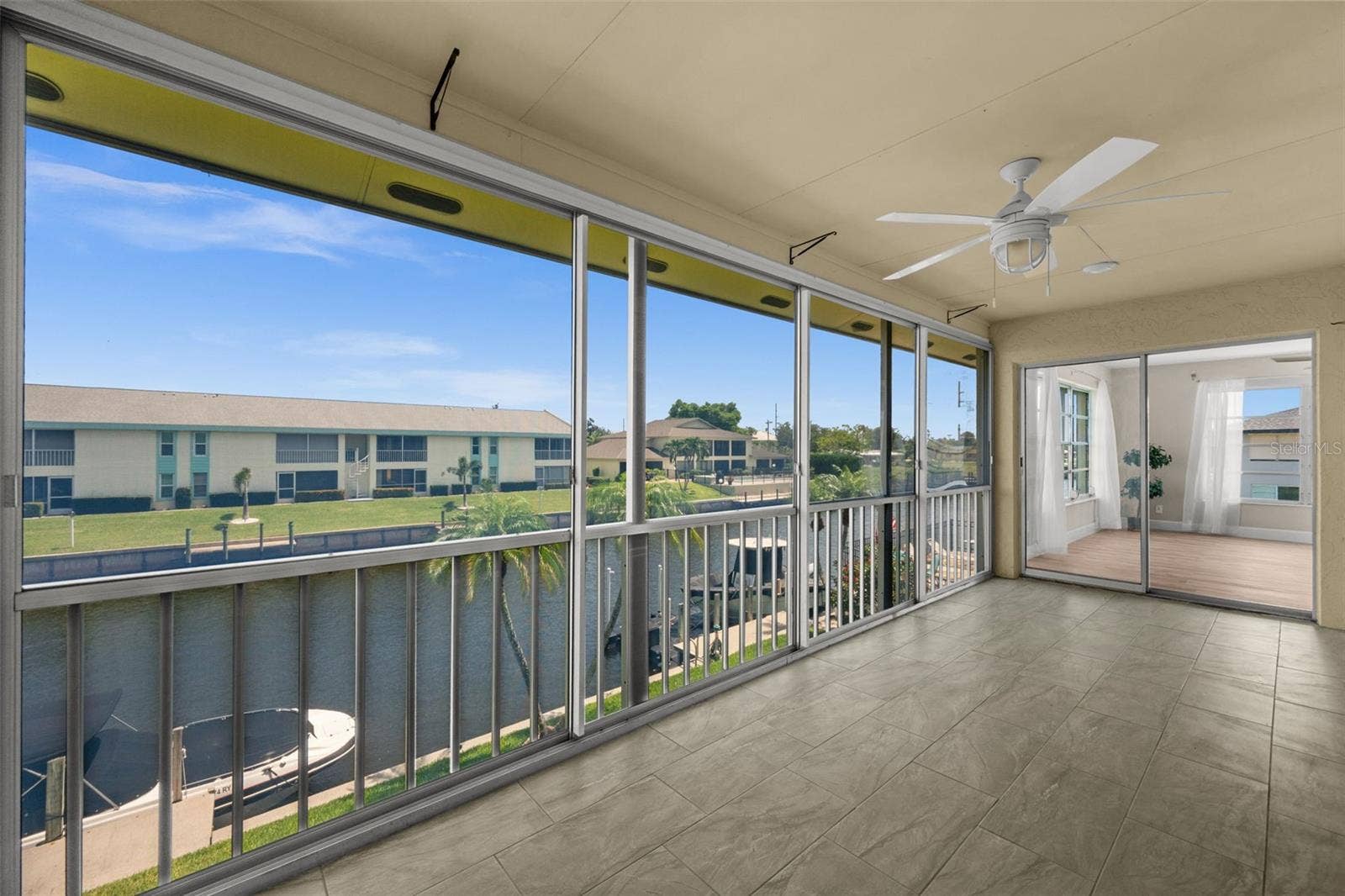 1345 SE 40TH TERRACE, #2E, Cape Coral, FL 33904 Lanai overlooking the canal with patio doors.