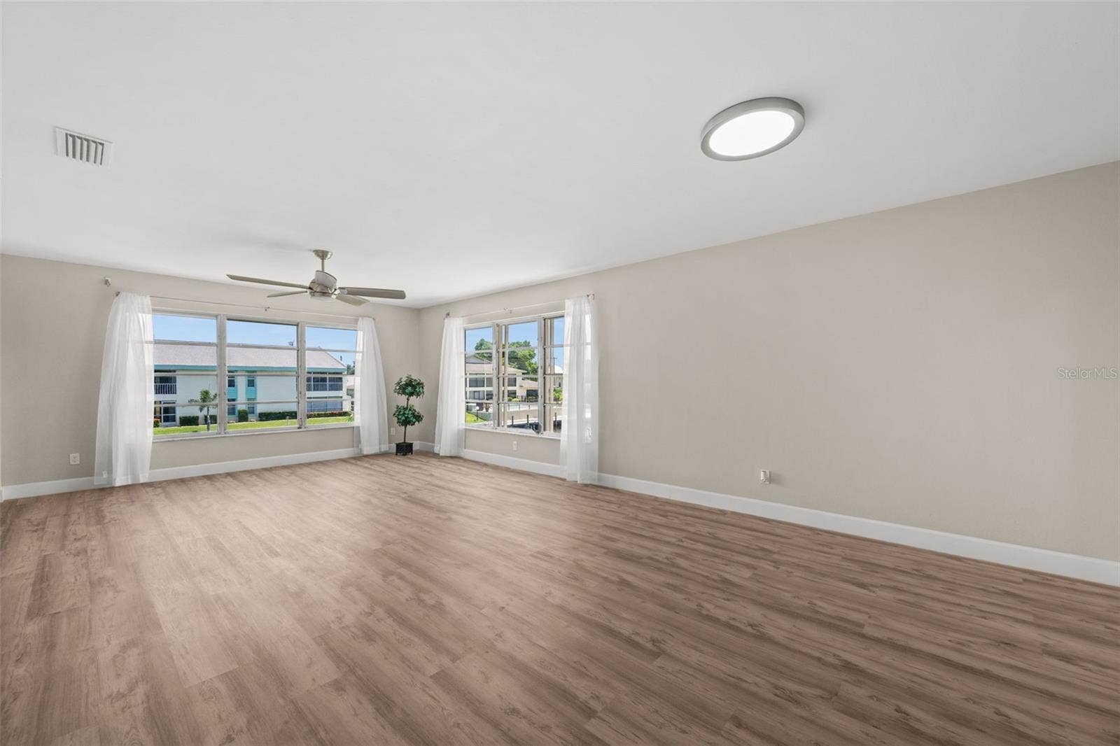 1345 SE 40TH TERRACE, #2E, Cape Coral, FL 33904 Living Room has tons of natural light from the corner windows that overlook the pool and canal