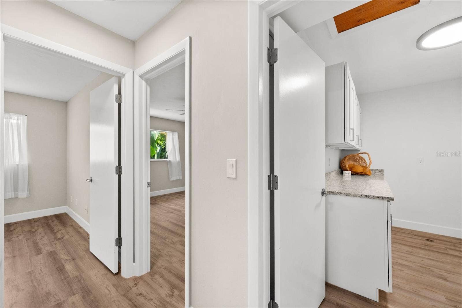 1345 SE 40TH TERRACE, #2E, Cape Coral, FL 33904 Hallway with access to laundry room and bedroom 2 and bedroom 3