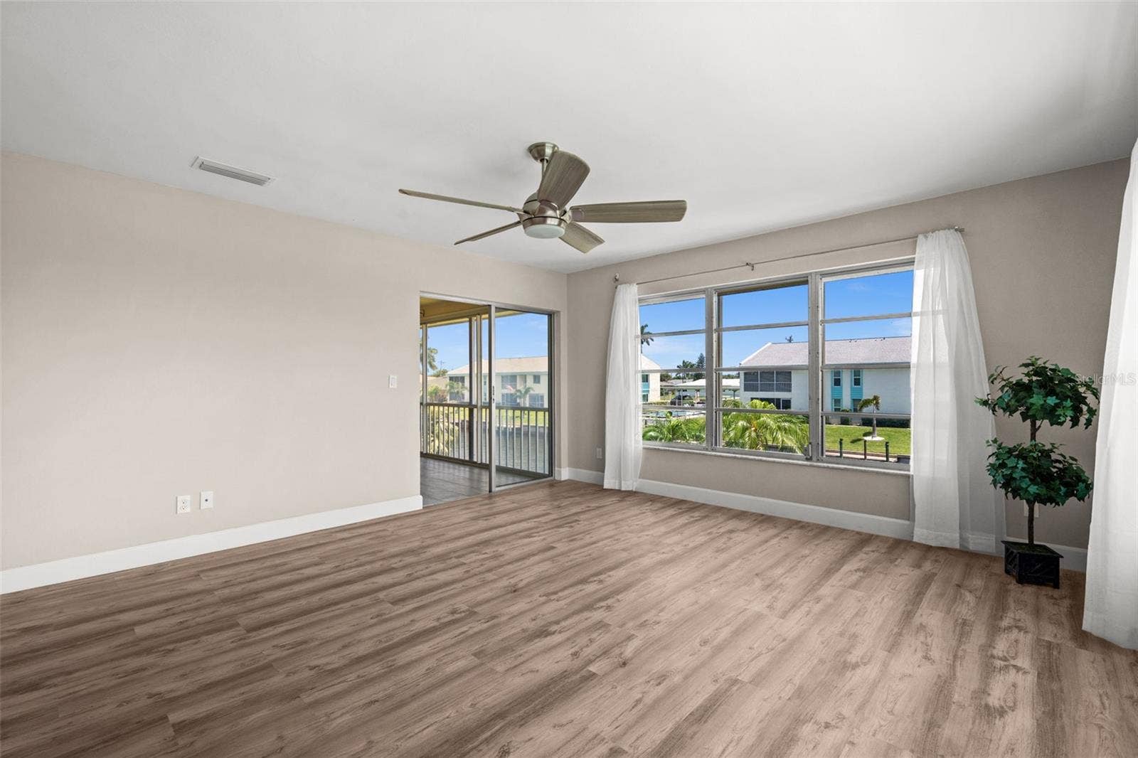 1345 SE 40TH TERRACE, #2E, Cape Coral, FL 33904 Living Room overlooks the canal and has access to the lanai