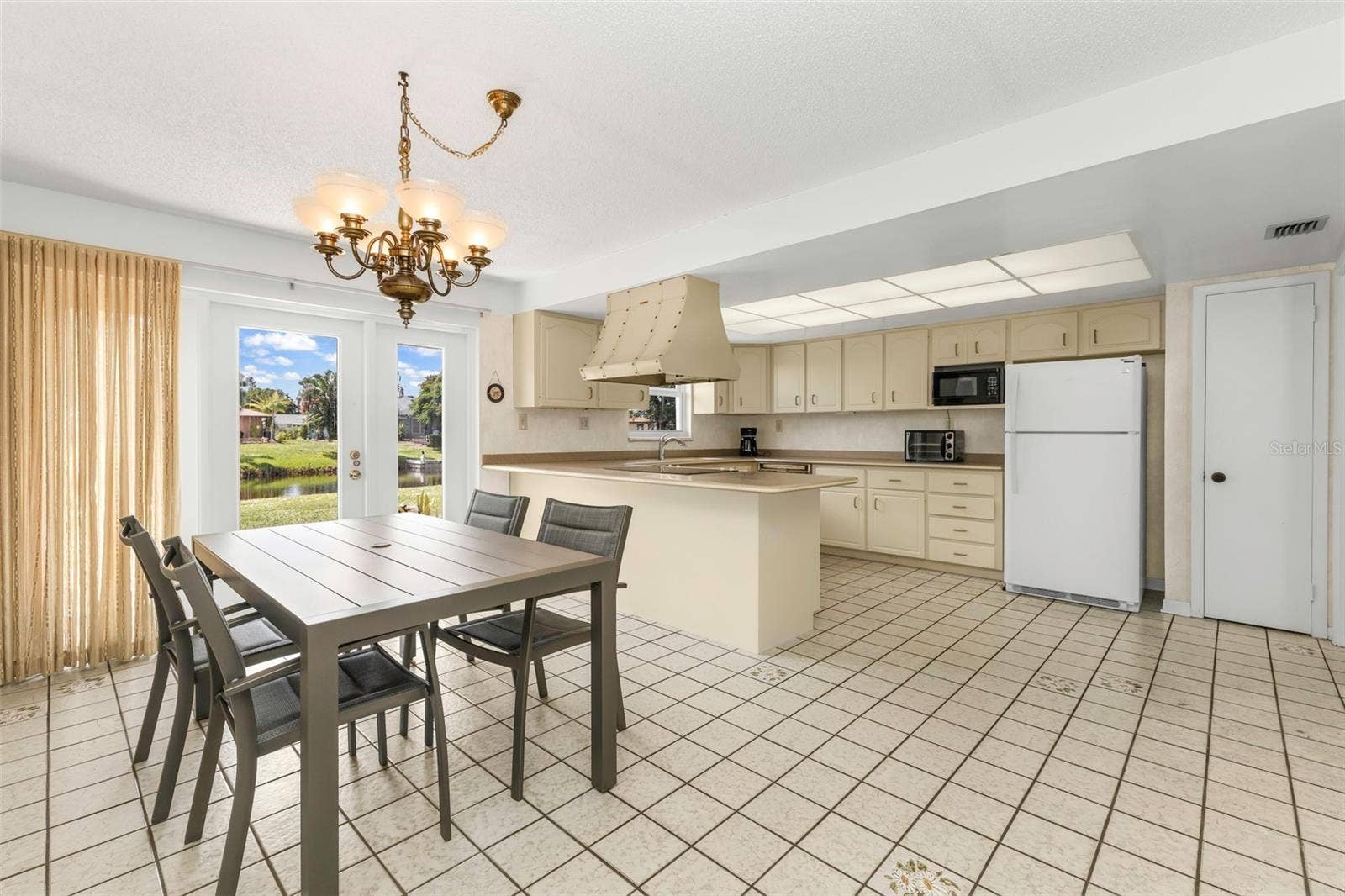 160 ANNAPOLIS LANE, Rotonda West, FL 33947 Functional kitchen with countertop breakfast bar and plenty of space for bar stools seating.