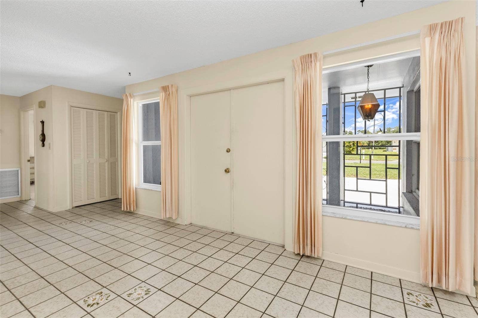 160 ANNAPOLIS LANE, Rotonda West, FL 33947 Entry way to the house through double doors, side entry to garage and laundry room, plus hallway closet/storage space and hallway bathroom.