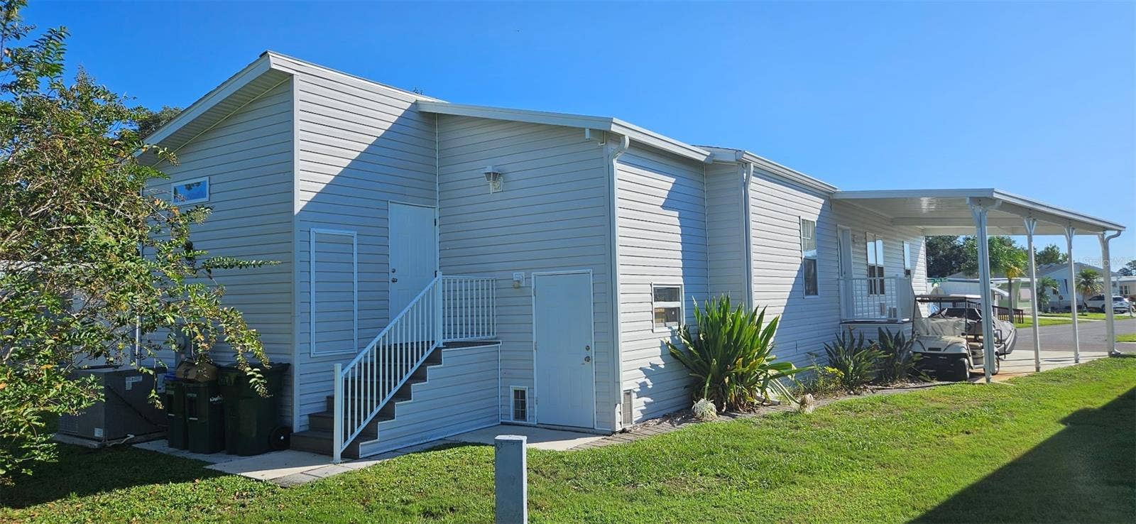 Back of home showing 2 story shed