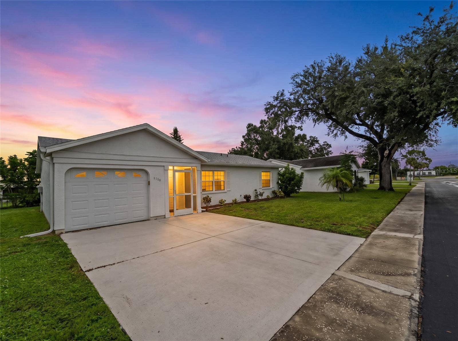 8130 PICKWICK ROAD, North Port, FL 34287 FrontExterior_8130PickwickRd_NorthPort_Driveway_Twilight.jpg