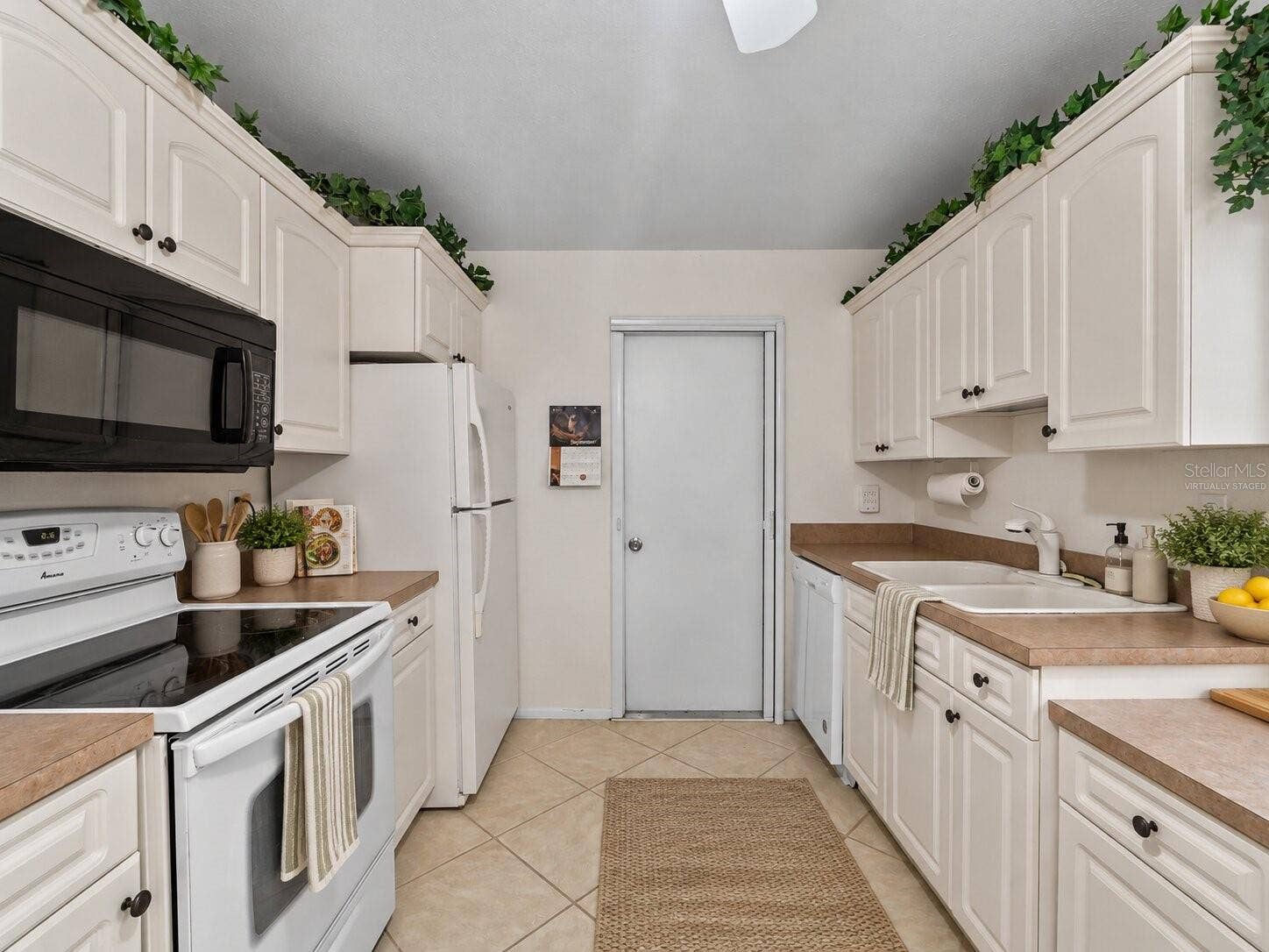 8130 PICKWICK ROAD, North Port, FL 34287 Virtually Staged Kitchen_8130PickwickRd_NorthPort_WhiteCabinetry_Wide2.jpg