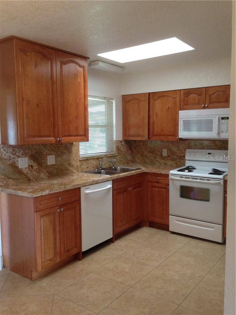 23040 JUMPER AVENUE, Port Charlotte, FL 33952 KITCHEN W/CERAMIC TILE, GRANITE COUNTERS, WOOD CABINETS