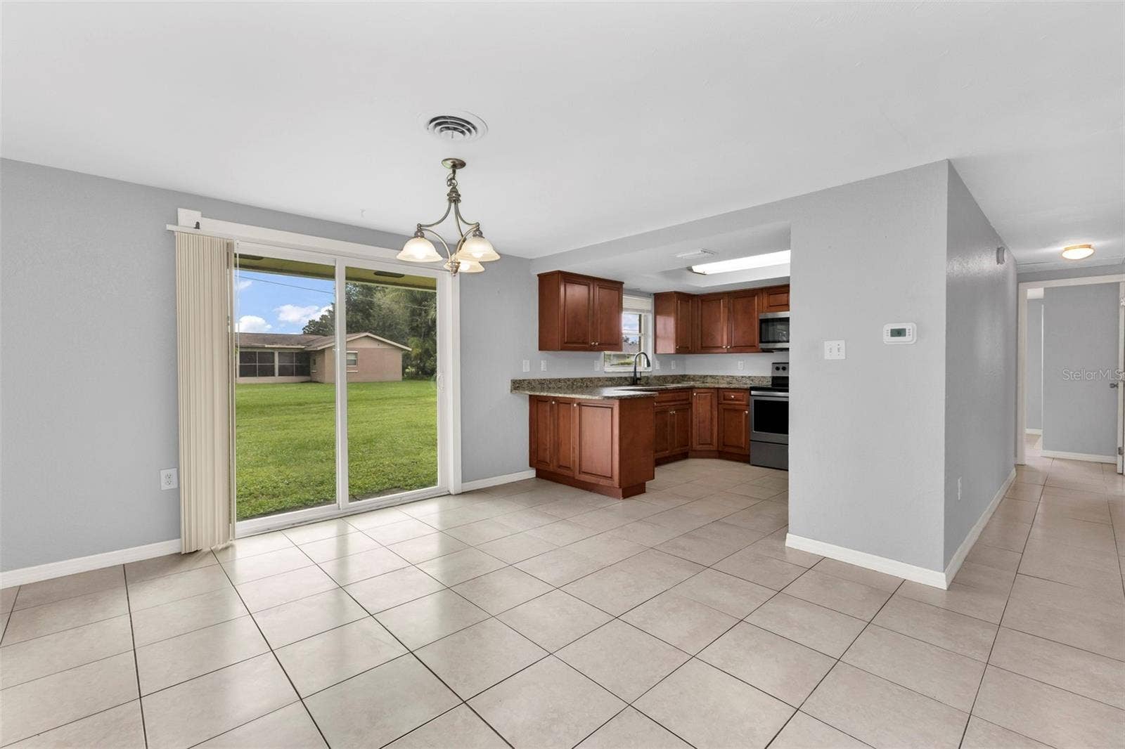 424 VANNELL STREET, Port Charlotte, FL 33954 Dining area off of kitchen with sliders to backyard.