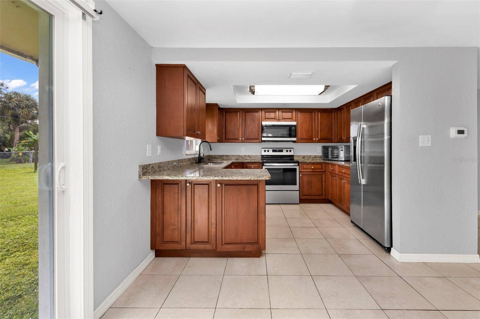 424 VANNELL STREET, Port Charlotte, FL 33954 Kitchen features granite countertops and stainless steel appliances.