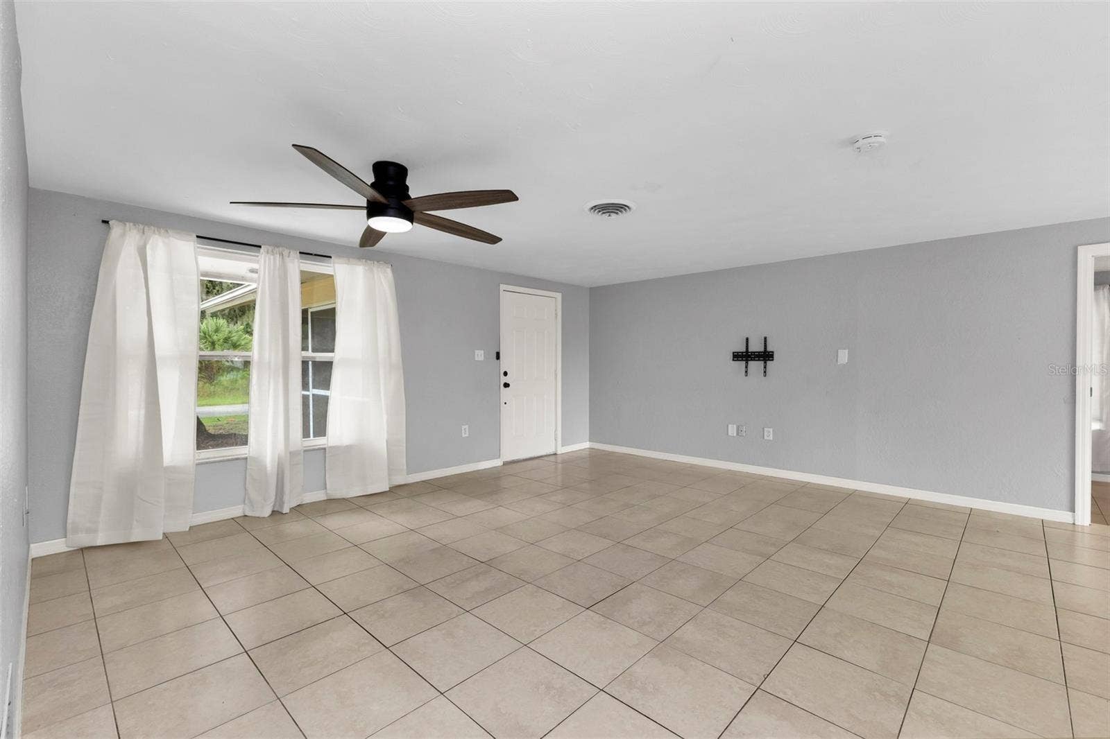 424 VANNELL STREET, Port Charlotte, FL 33954 Living room with tile throughout the home.
