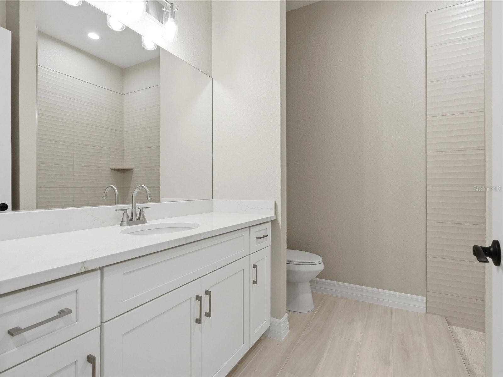 Guest Bathroom with tiled shower & linen closet