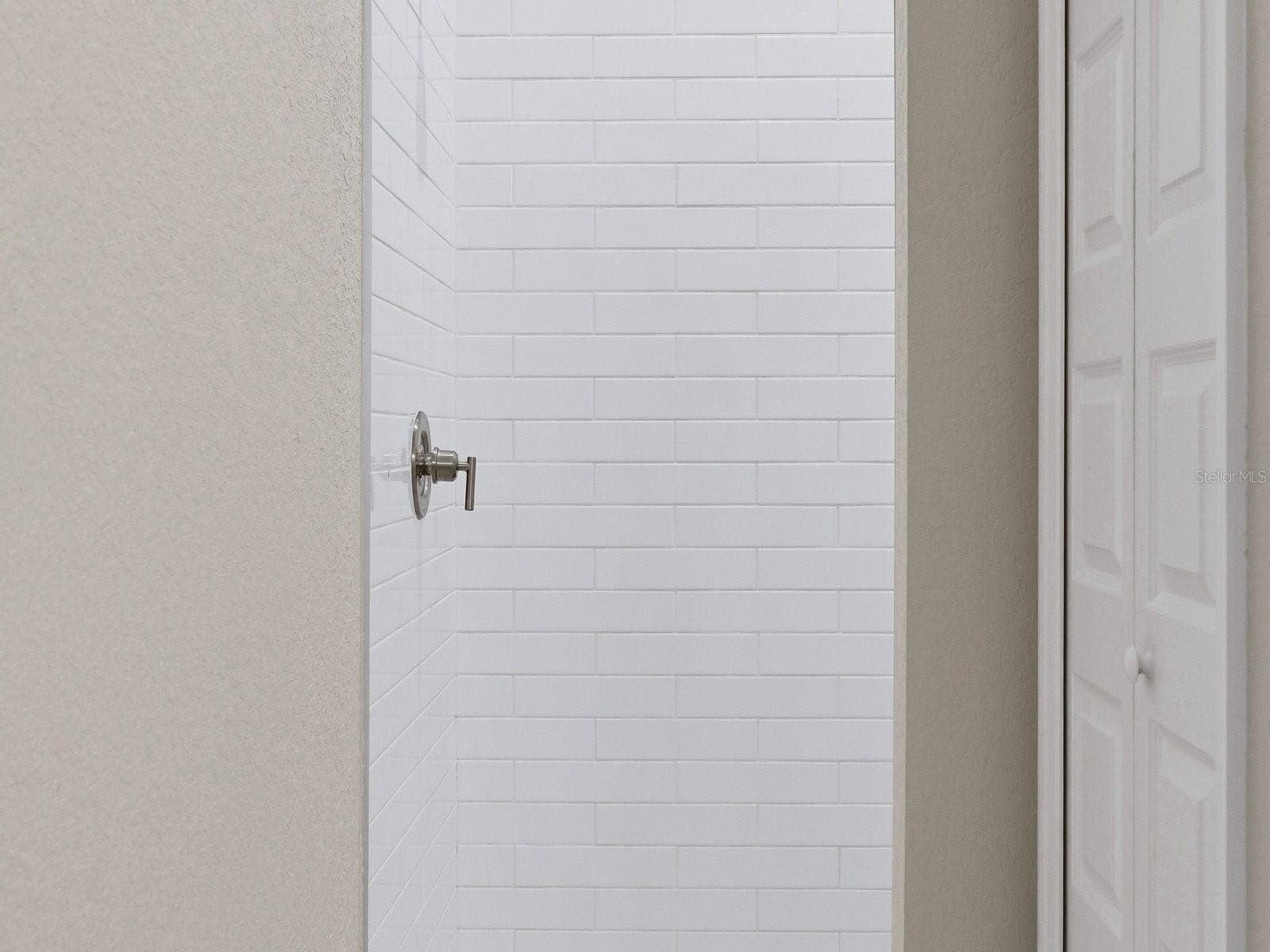 Junior Primary Shower with fabulous penny tiled floor