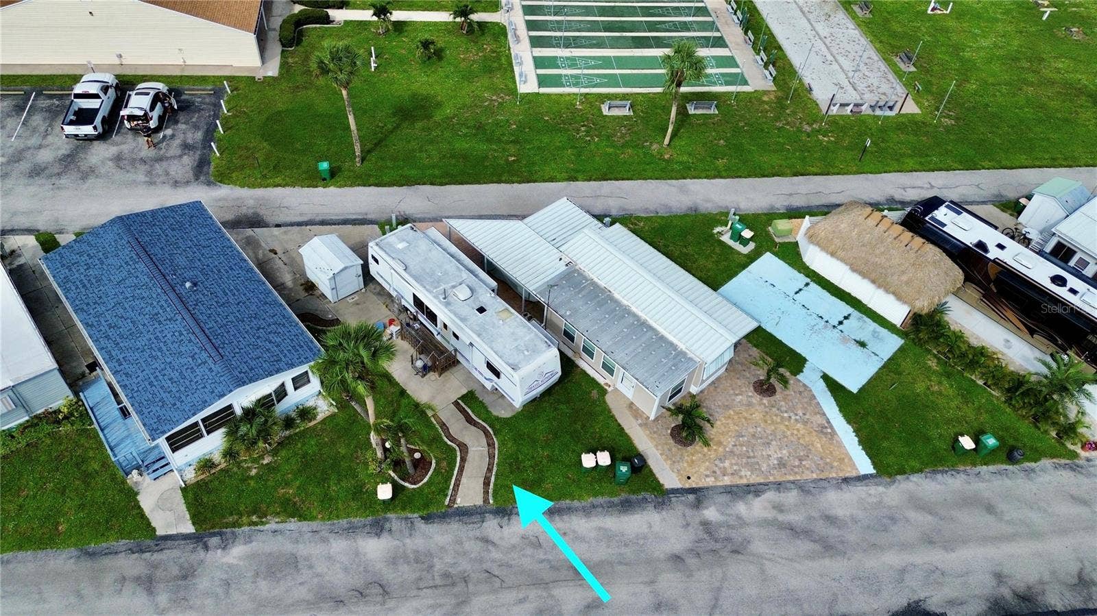Aerial of lot and RV that is being left at the property for convenience of the seller/buyer.