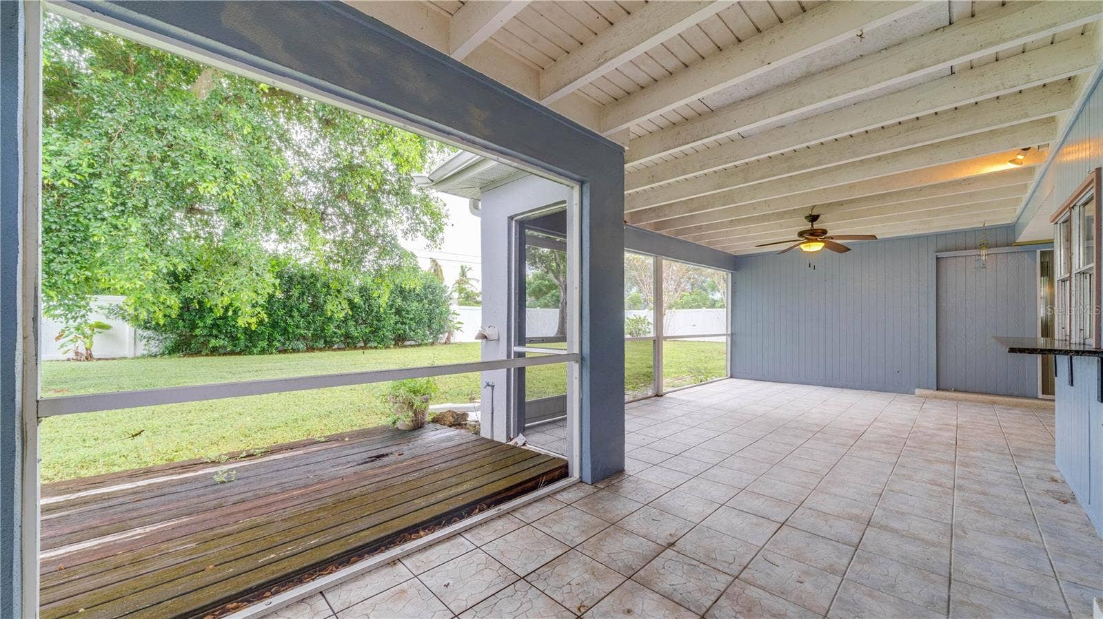 The oversized, tiled lanai showcases an exposed beam ceiling and so much room for your outdoor oasis.