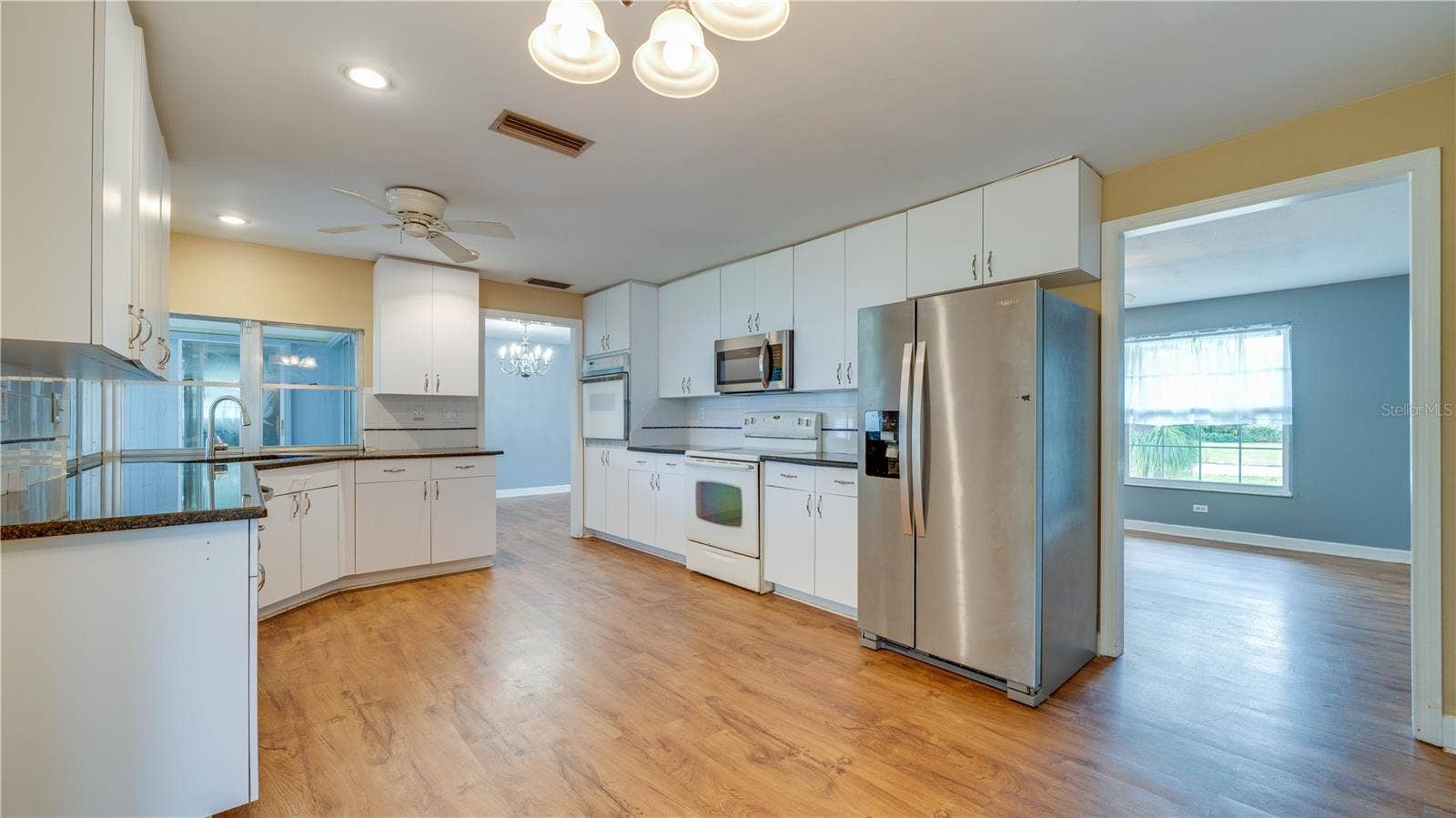 Spacious kitchen featuring LVT flooring.