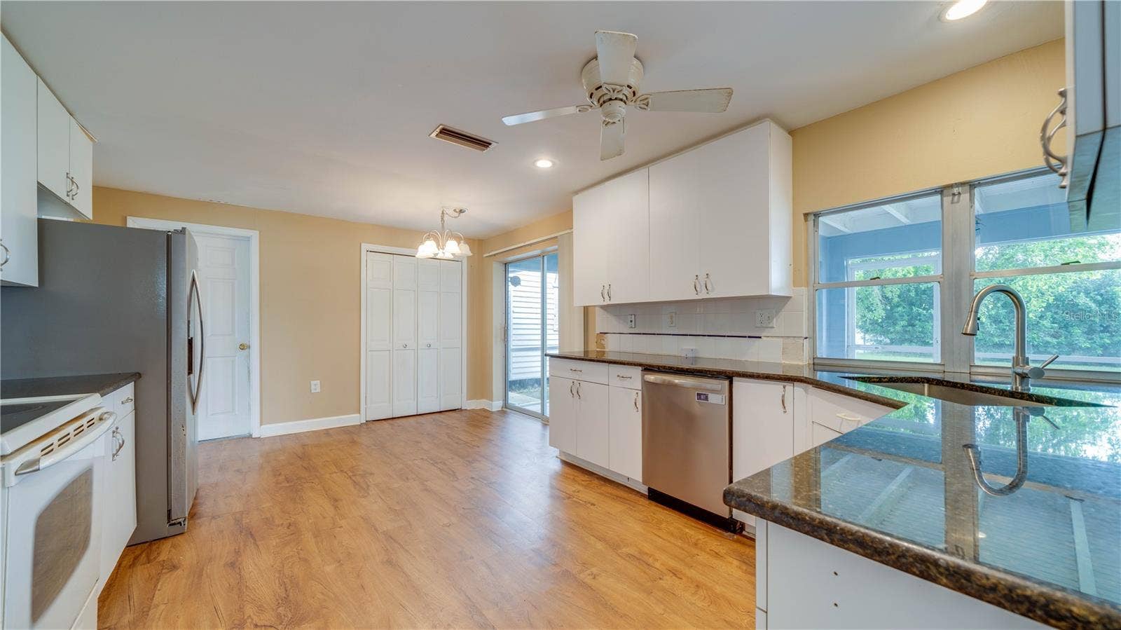 Notice the large pantry and abundant cabinetry.