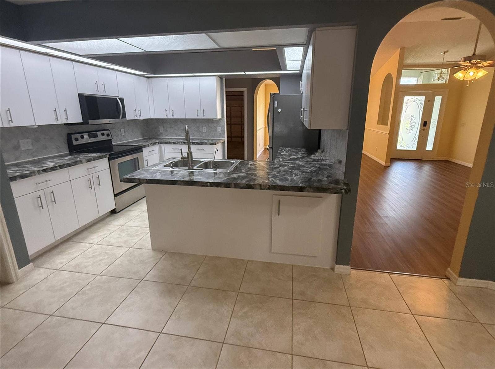 4055 ALLURE LANE, North Port, FL 34287 Kitchen with eat at counters. View of Living Room.