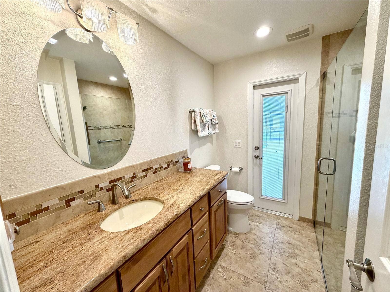 23411 MULLINS AVENUE, Port Charlotte, FL 33954 Guest Bathroom looking toward the pool door