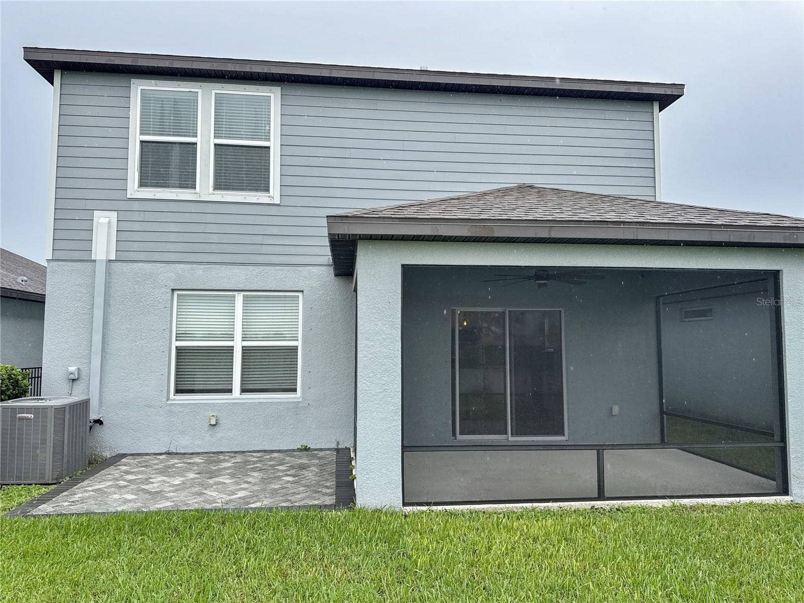 exterior back view of home showing covered and screened lanai
