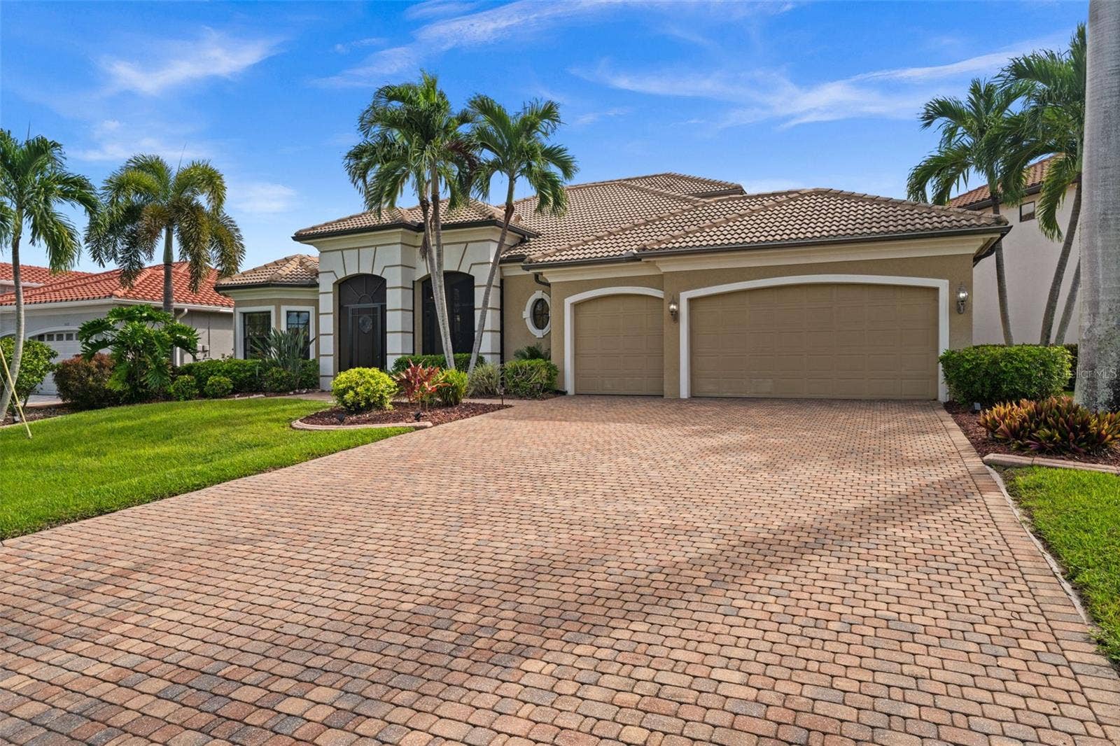 Paver driveway, 3 car garage and tile roof complete the package