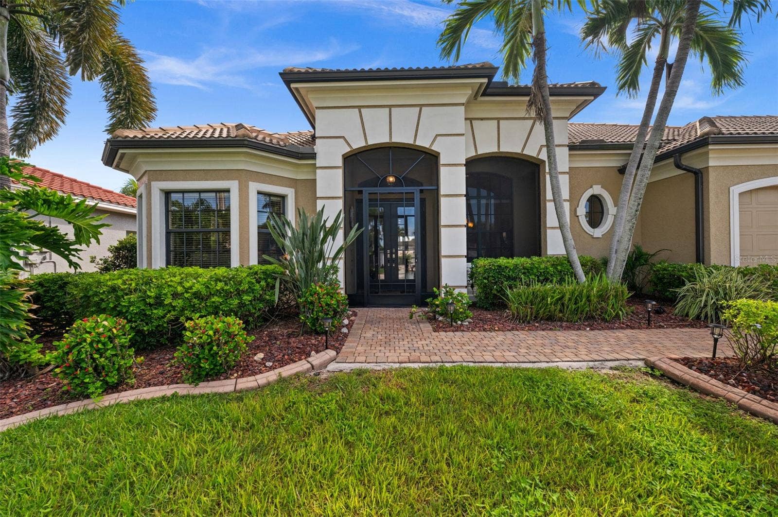 A stately entrance with soaring arches and custom brickwork