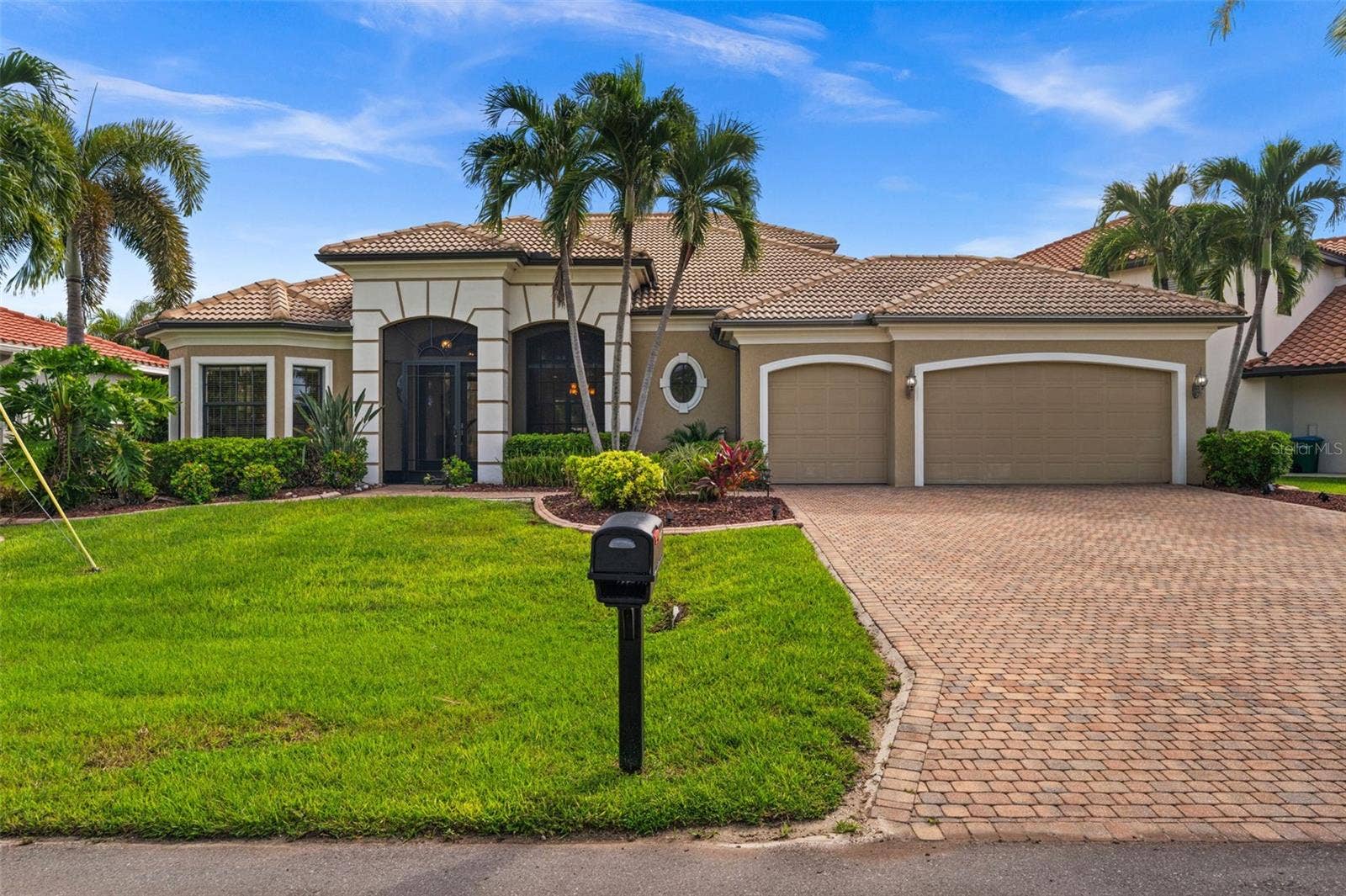 Mature tropical landscaping and that majestic Custom Home look