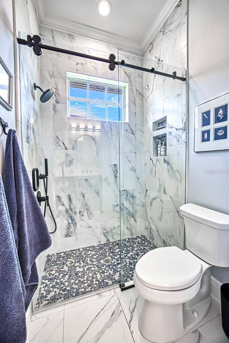 8625 SOUTHWIND BAY CIRCLE, Fort Myers, FL 33908 Shower with barn door glass doors - tiled walls