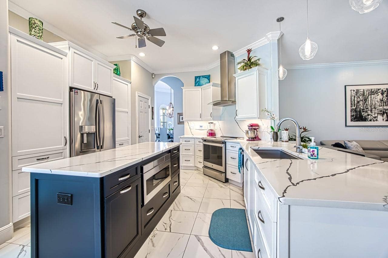 8625 SOUTHWIND BAY CIRCLE, Fort Myers, FL 33908 Custom cabinets with built in microwave. Pull out drawers for easy access and tall Cabinets with pull out shelving