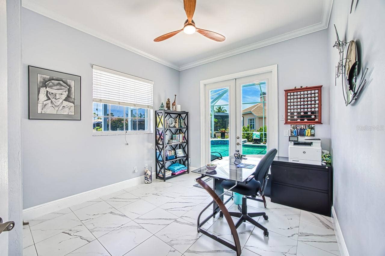 8625 SOUTHWIND BAY CIRCLE, Fort Myers, FL 33908 4th bedroom with hurricane french doors opening to pool area - also has fabric hurricane shutters for added protection