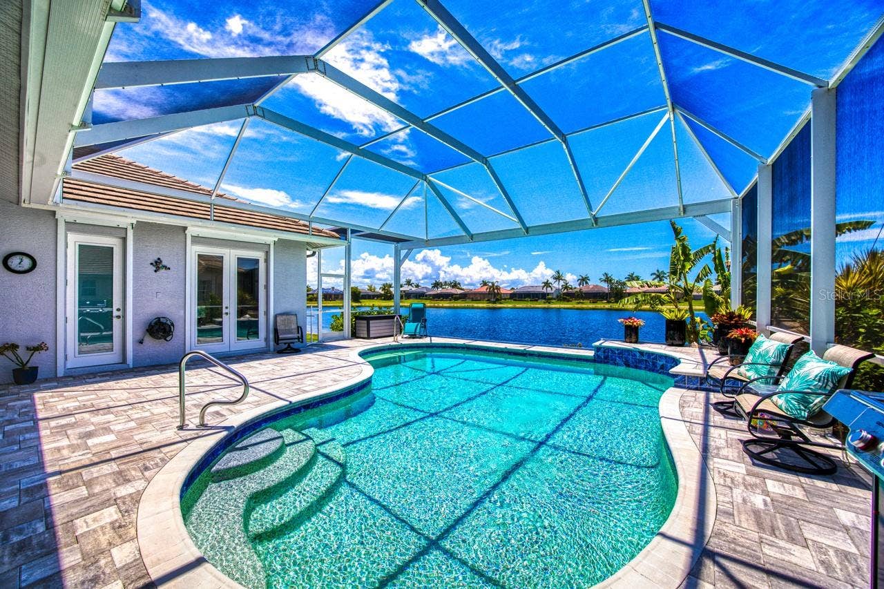 8625 SOUTHWIND BAY CIRCLE, Fort Myers, FL 33908 Screen lanai with picture window to lake in 2022