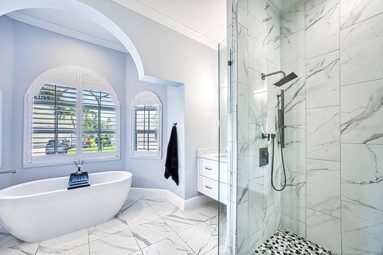 8625 SOUTHWIND BAY CIRCLE, Fort Myers, FL 33908 Updated primary bath with walk in shower and separate tub. Wall mounted vanities