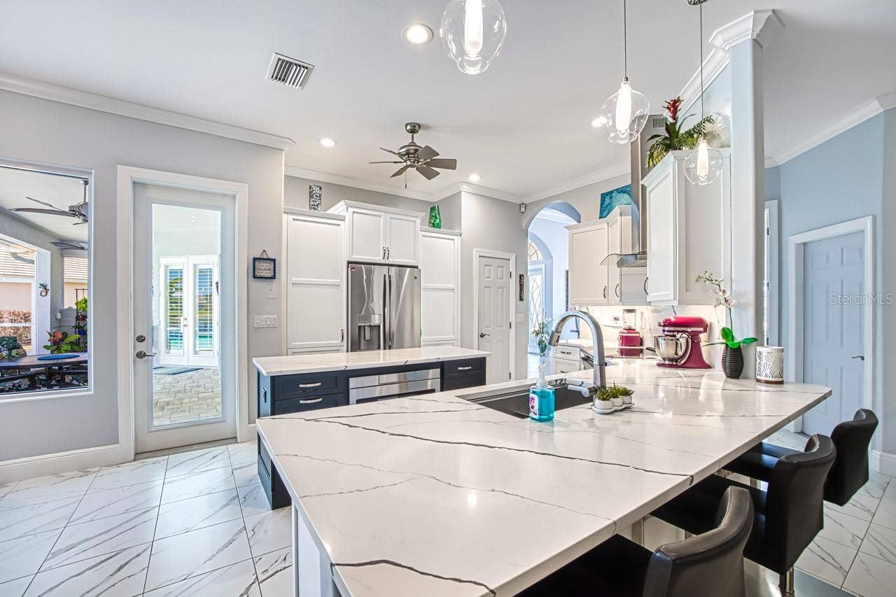 8625 SOUTHWIND BAY CIRCLE, Fort Myers, FL 33908 Kitchen opens to family room with fireplace