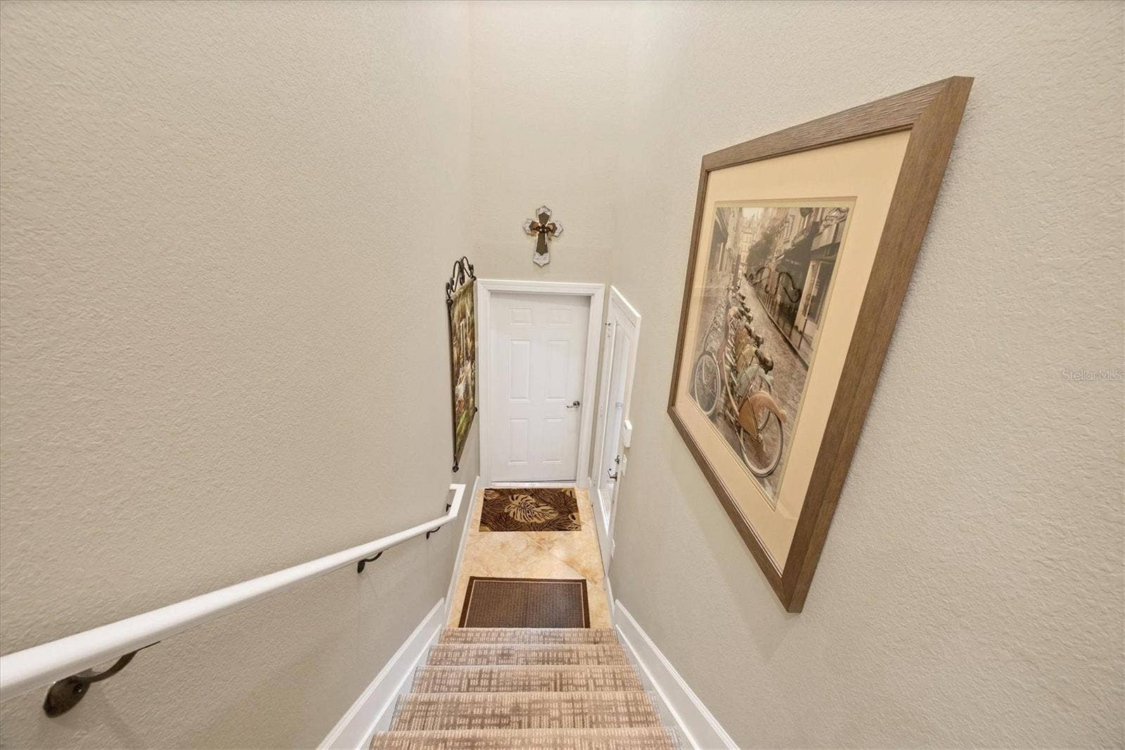 Stairs to enter -  new carpet. Door to garage.