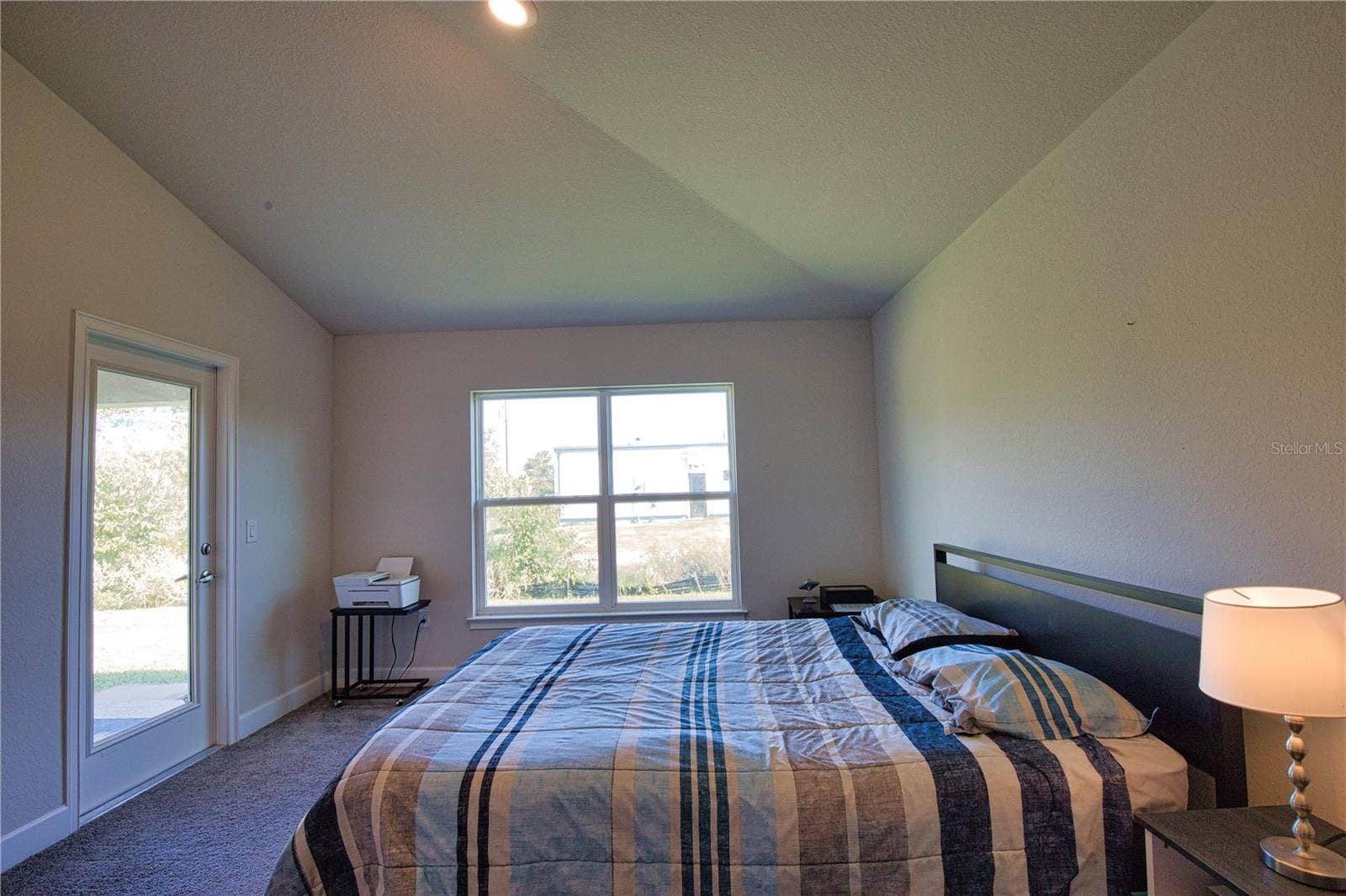 14062 HOPEWELL AVENUE, Port Charlotte, FL 33981 Primary bedroom with door out to the covered lanai