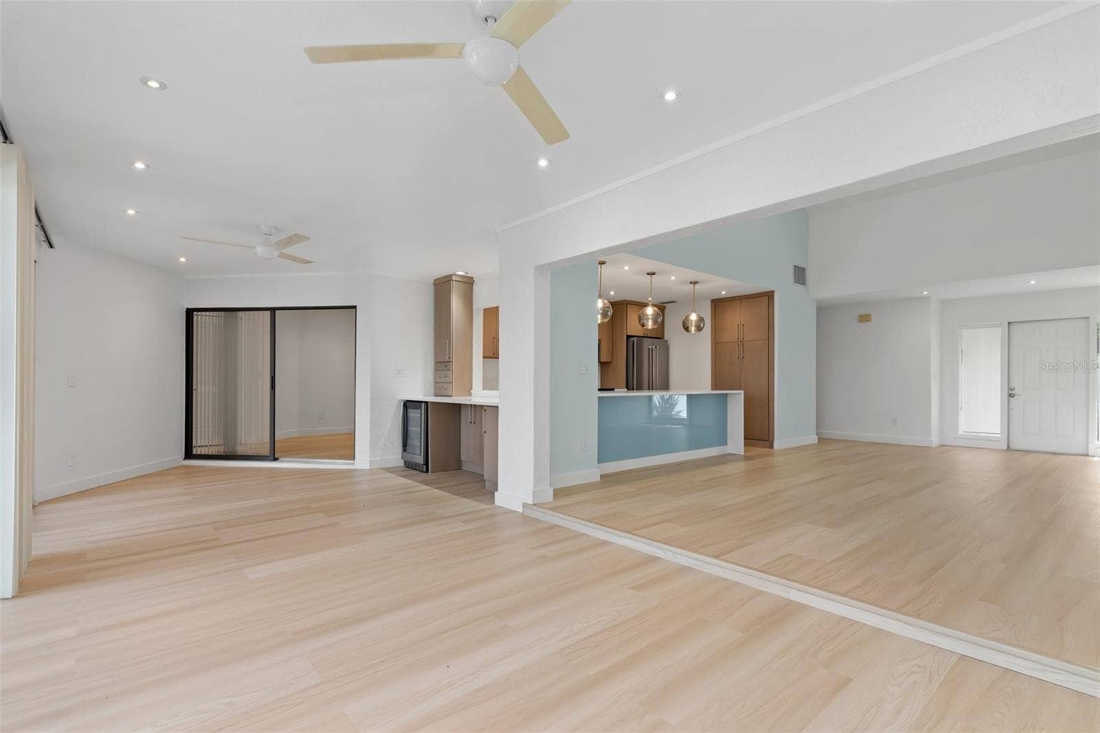 5021 SAN ROCCO COURT, Punta Gorda, FL 33950 Standing at back sliders of family room and looking at open interior space. Dining, wine cooler, entertainment area.