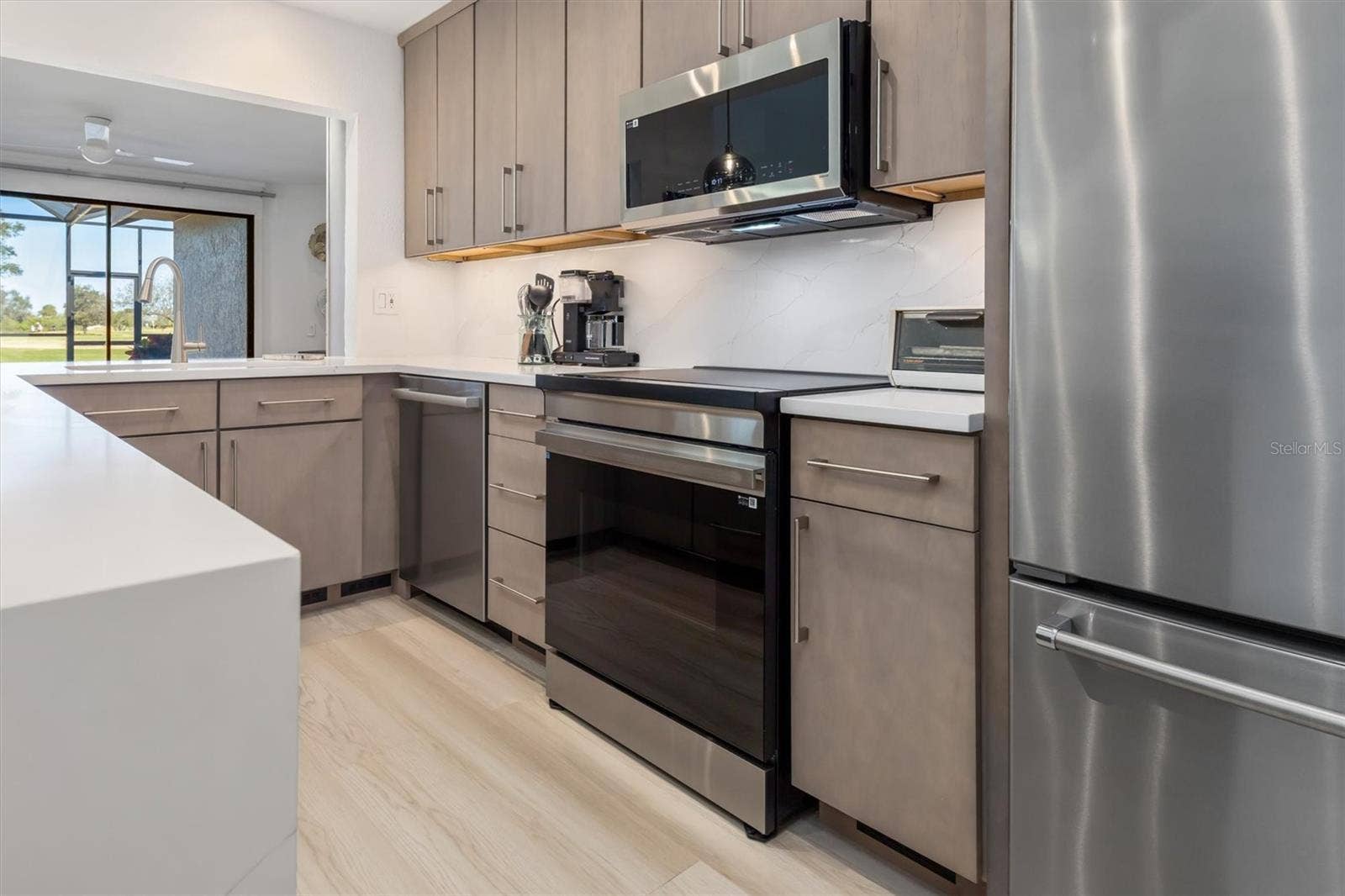 5021 SAN ROCCO COURT, Punta Gorda, FL 33950 Induction range. Pass through to dining room.