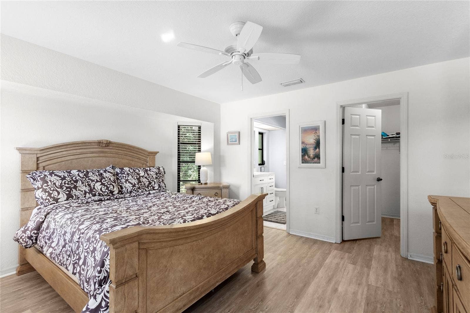 18346 KOALA AVENUE, Port Charlotte, FL 33948 Primary Suite with laminate flooring and walk-in closet.