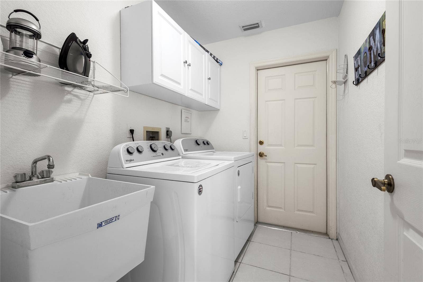 18346 KOALA AVENUE, Port Charlotte, FL 33948 Laundry Room with laundry tub and cabinets.