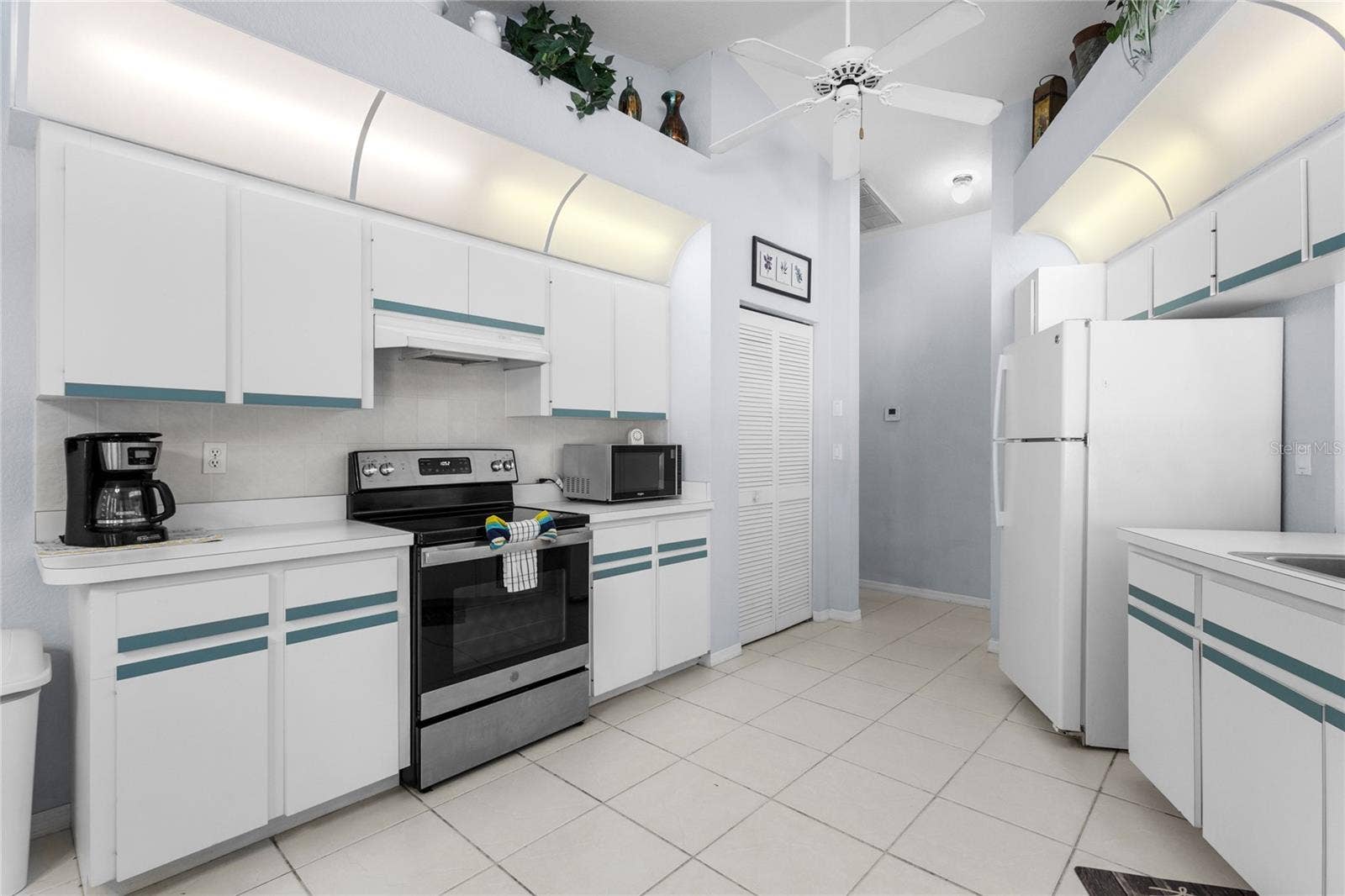 18346 KOALA AVENUE, Port Charlotte, FL 33948 Large Kitchen with pantry and plant shelves.
