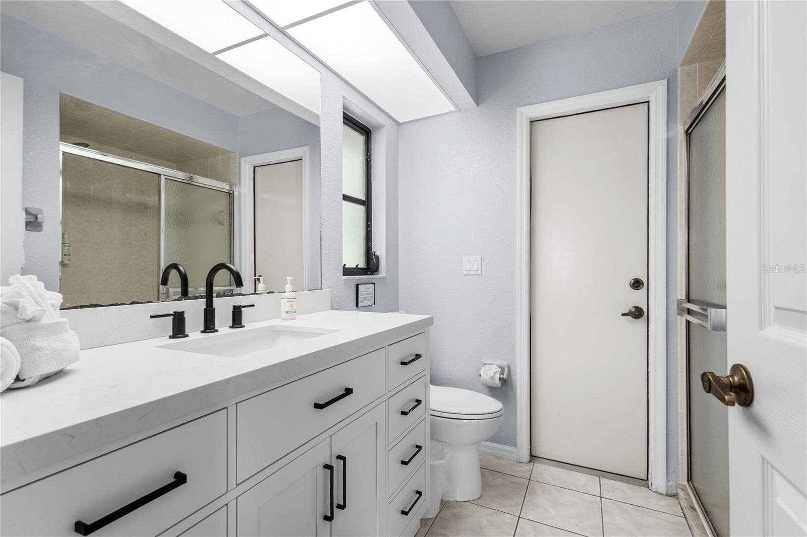 18346 KOALA AVENUE, Port Charlotte, FL 33948 Primary Suite Bathroom with access to the Lanai and pool.