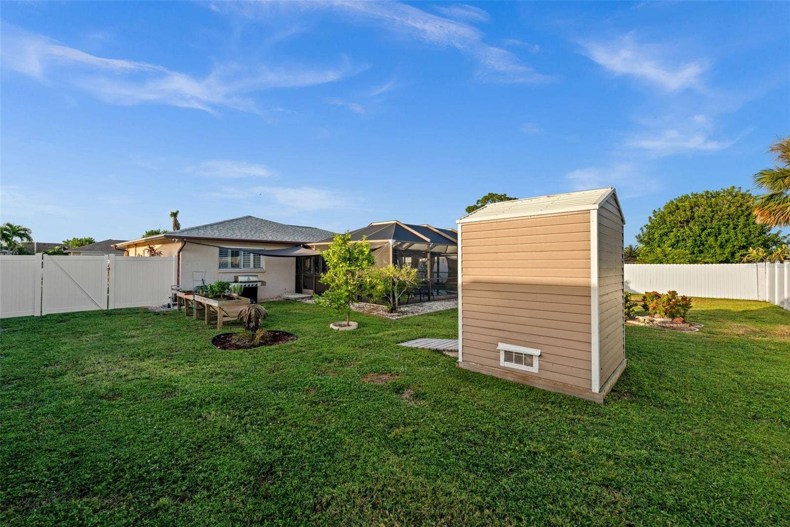 Fully fenced back yard. Raised flower beds, and a shed for extra storage.