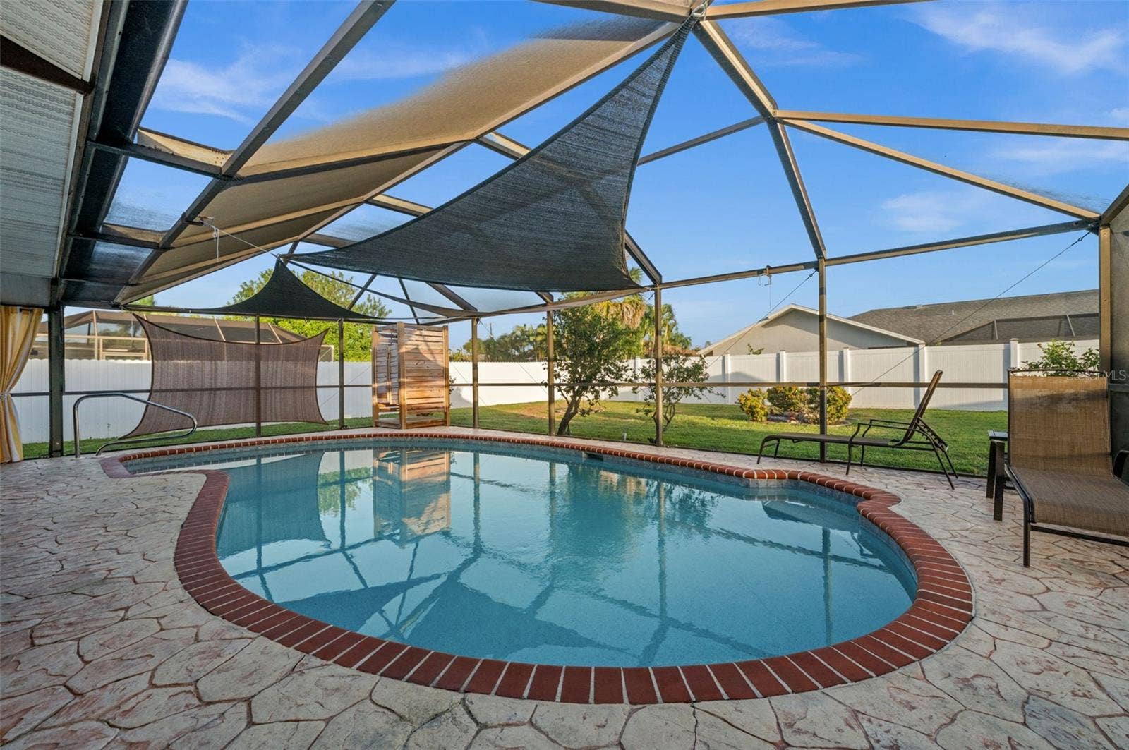 A heated pool. Sunshades, and a privacy fence...all in place.