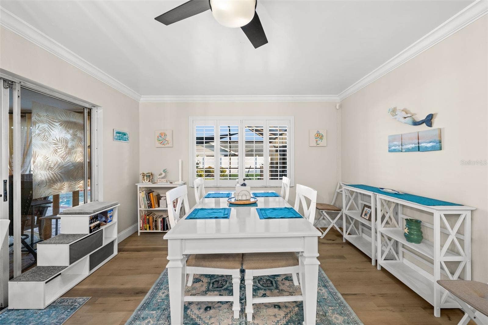 A neutral palette, crown molding, and plantation shutters - all warm and inviting.