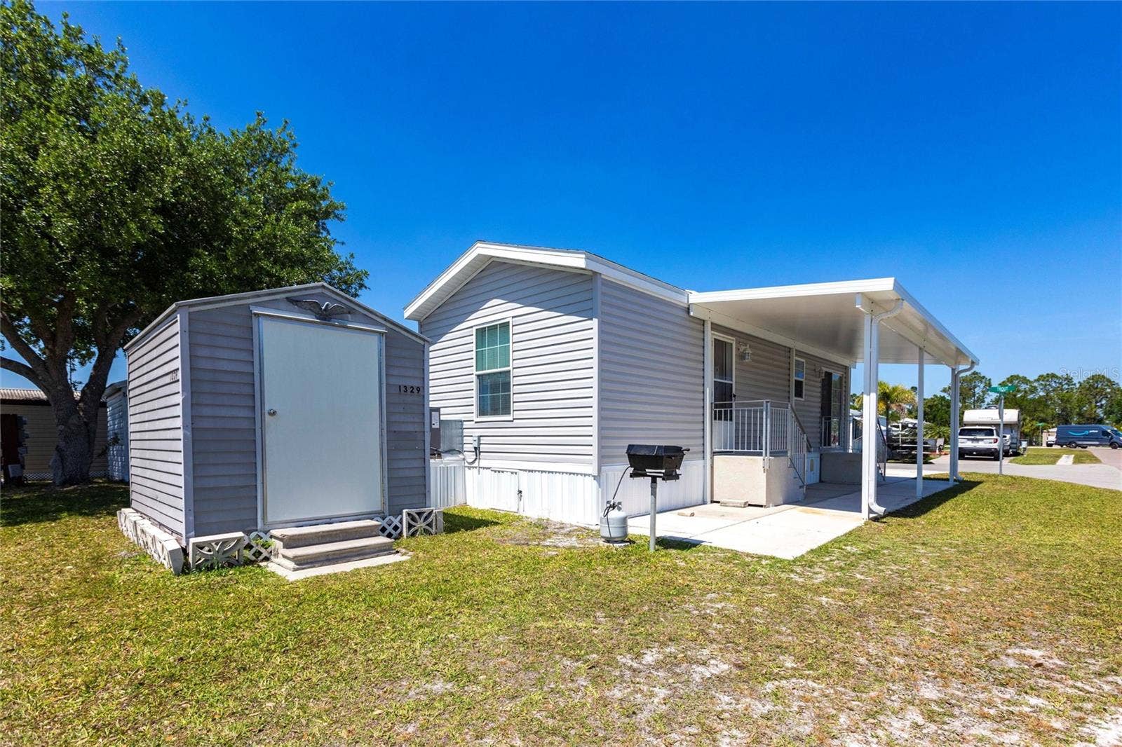 1329 TROUT, Punta Gorda, FL 33950 Side of home with shed and bbq