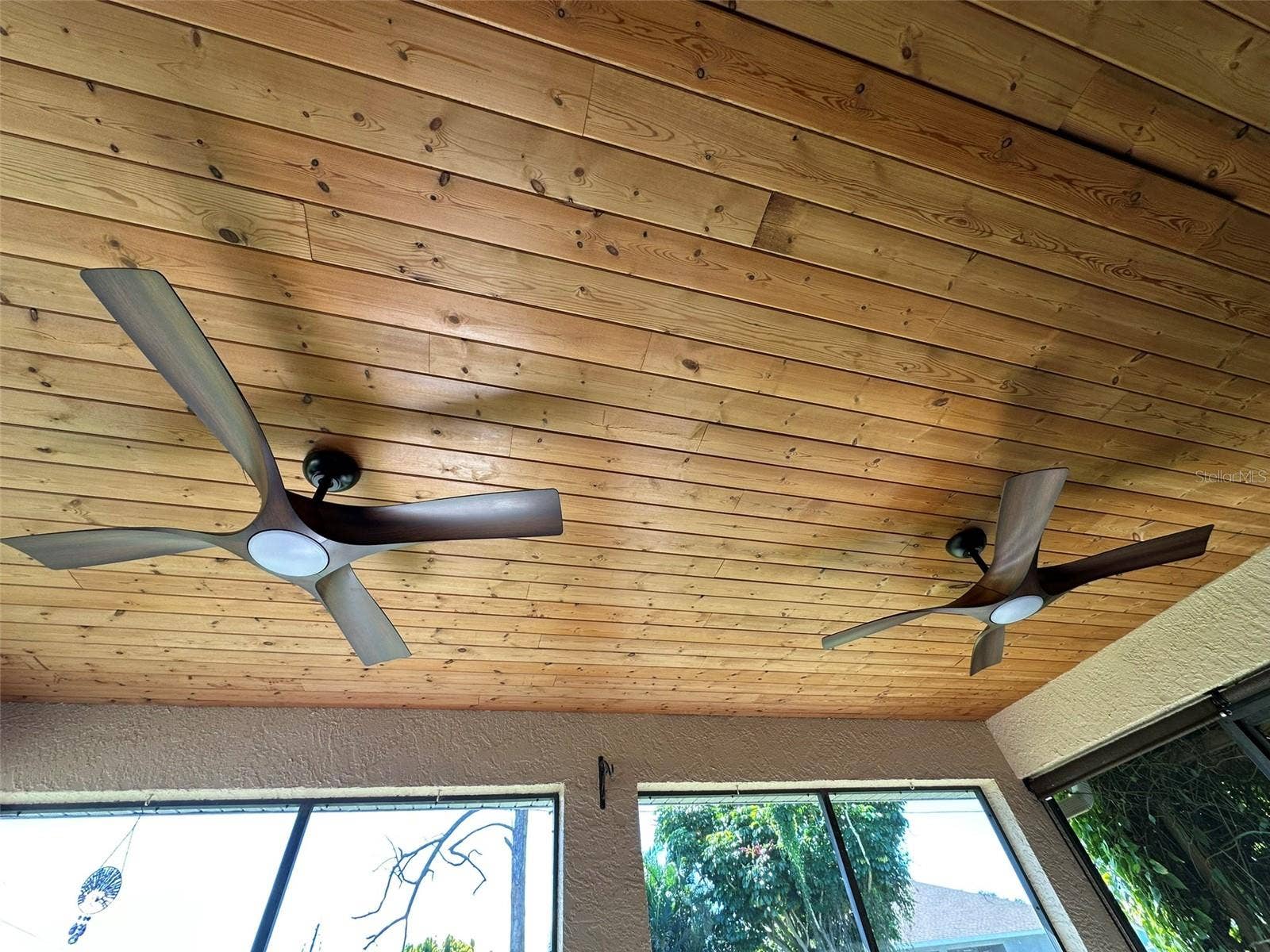 tongue and groove pine ceiling with 2 new 8 speed fans