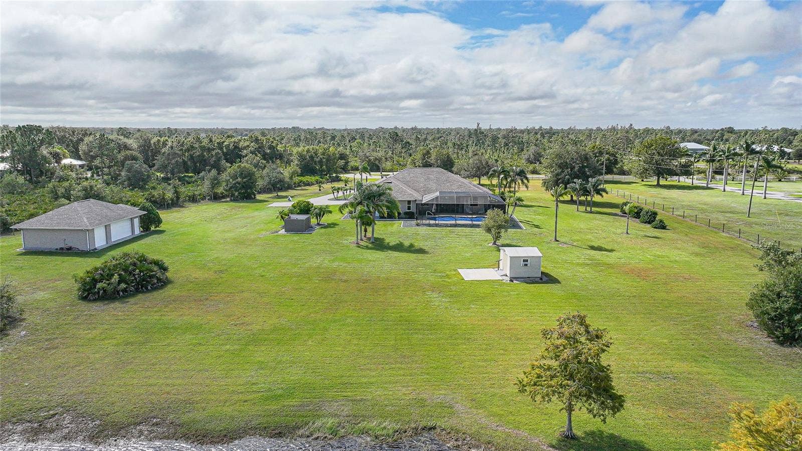 Estate Features 6.39 Acres, 5 Car Garage, Shed with Patio and Electric, Stocked Pond, Gated Entry, Paver Drive, Community Equestrian Trails